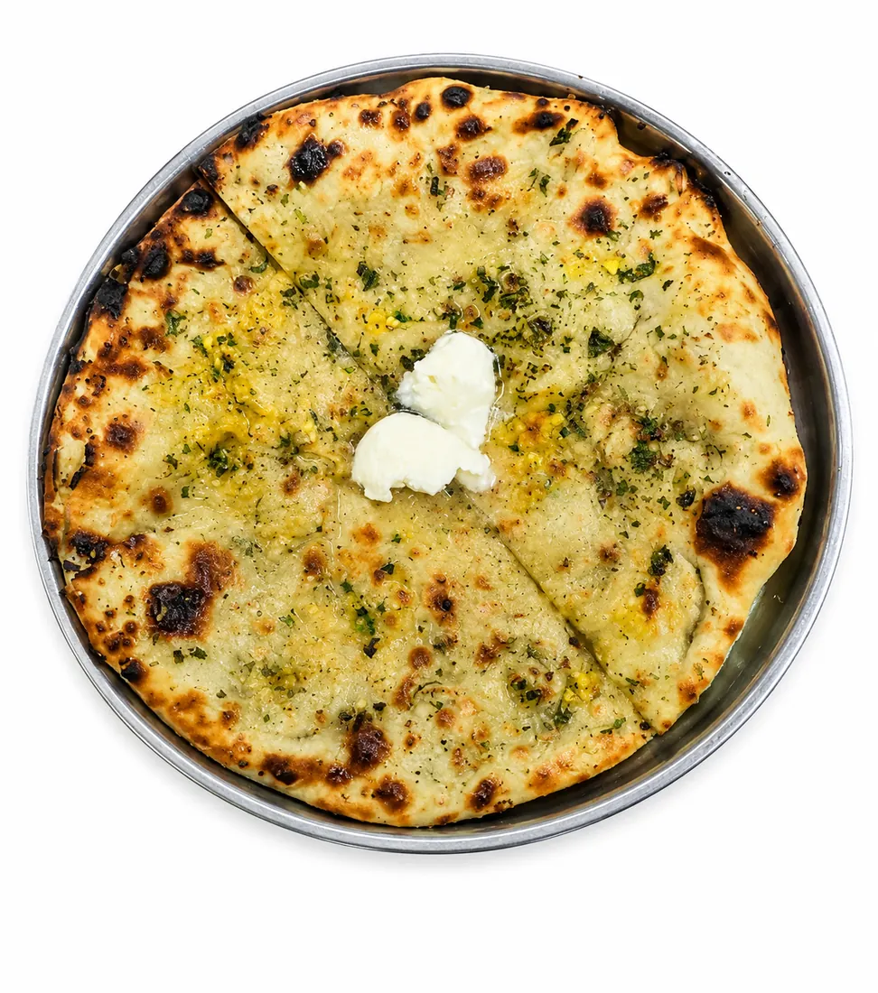 Signature Amritsari kulcha, fresh off the tandoor
